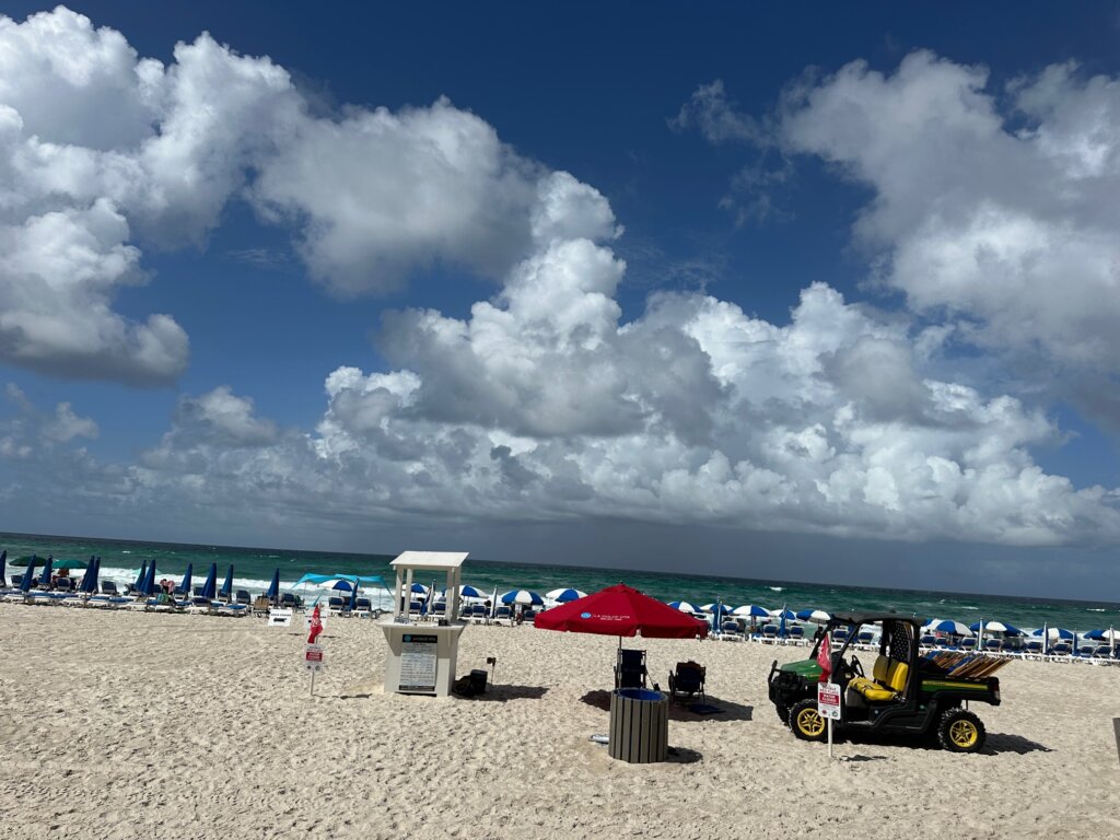 Beach with blue and white umbrellas