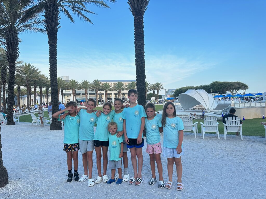 Children in matching shirts near beach