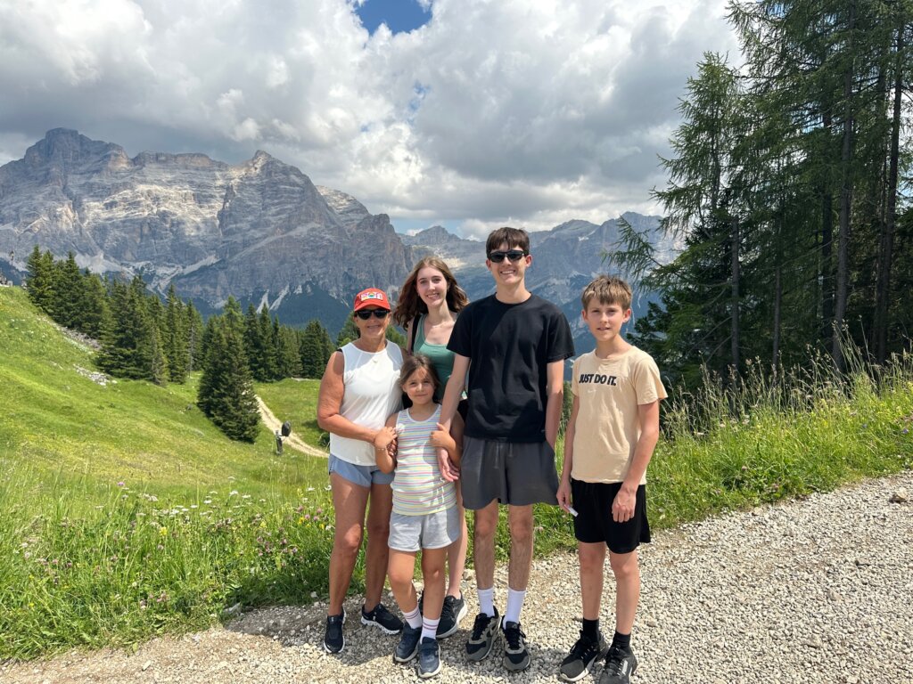 Woman with four children in front of mountain