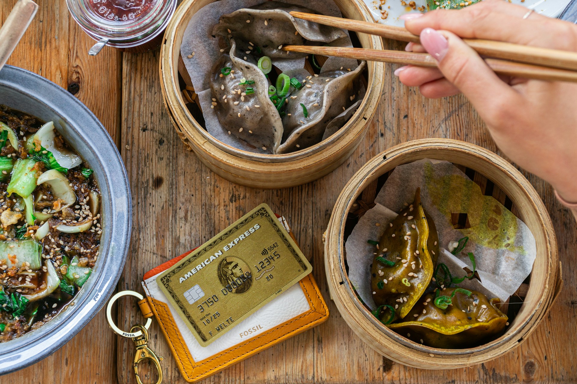 Gold credit card near bowls of dumplings