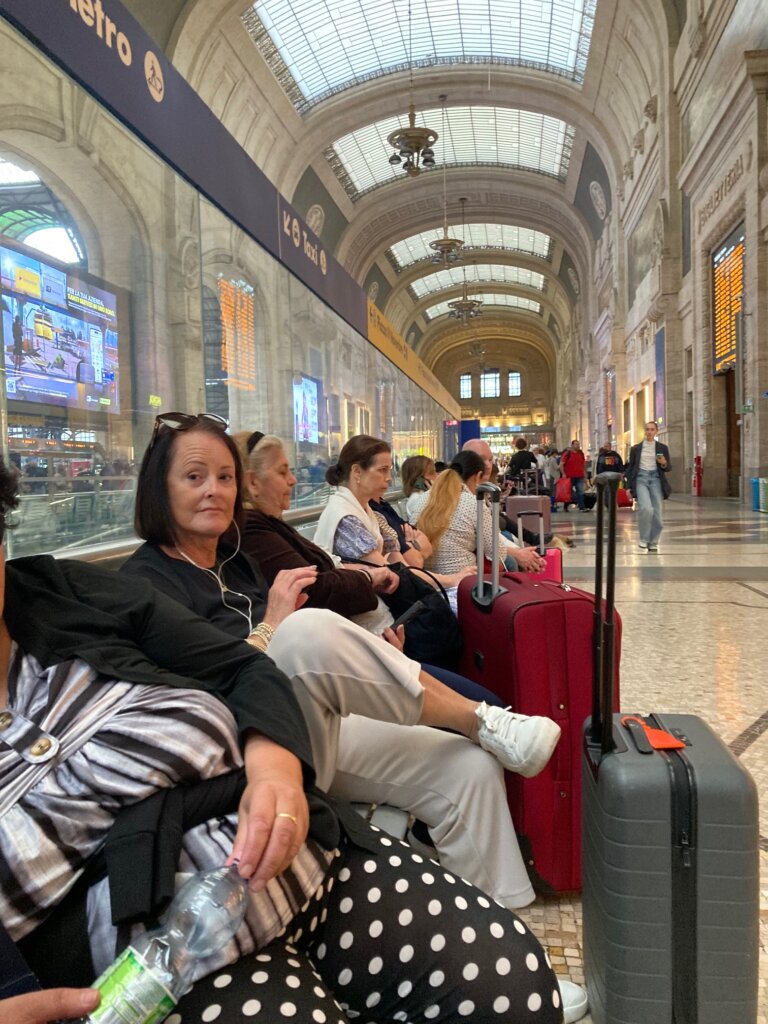 Woman sitting on chair in train station