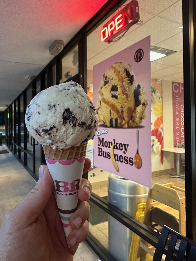 Ice cream cone held by Baskin Robbins store.