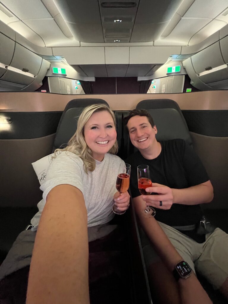 Couple on airplane with champagne