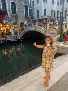 Little girl with gelato by canal