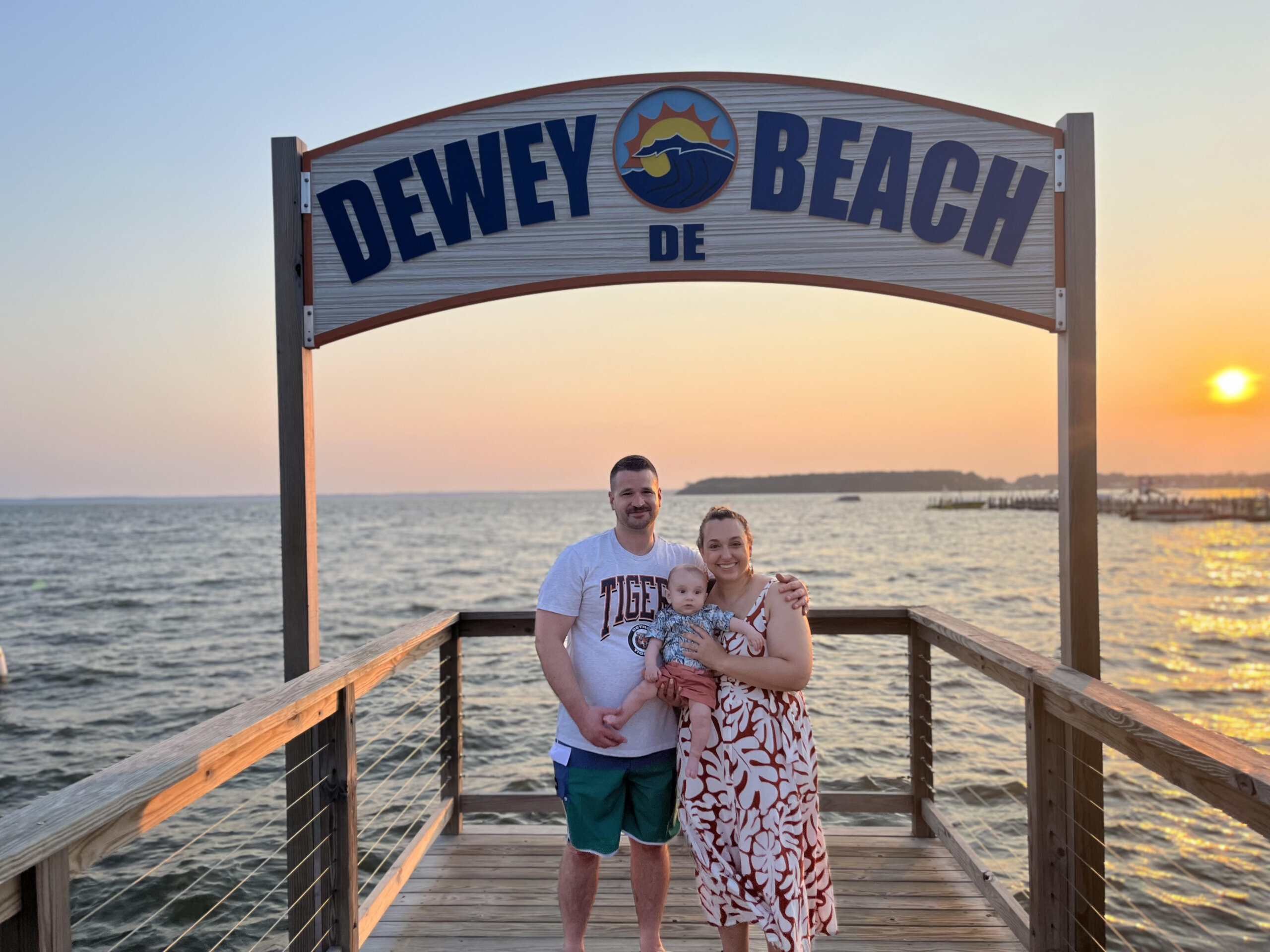 Family under Dewey Beach sign